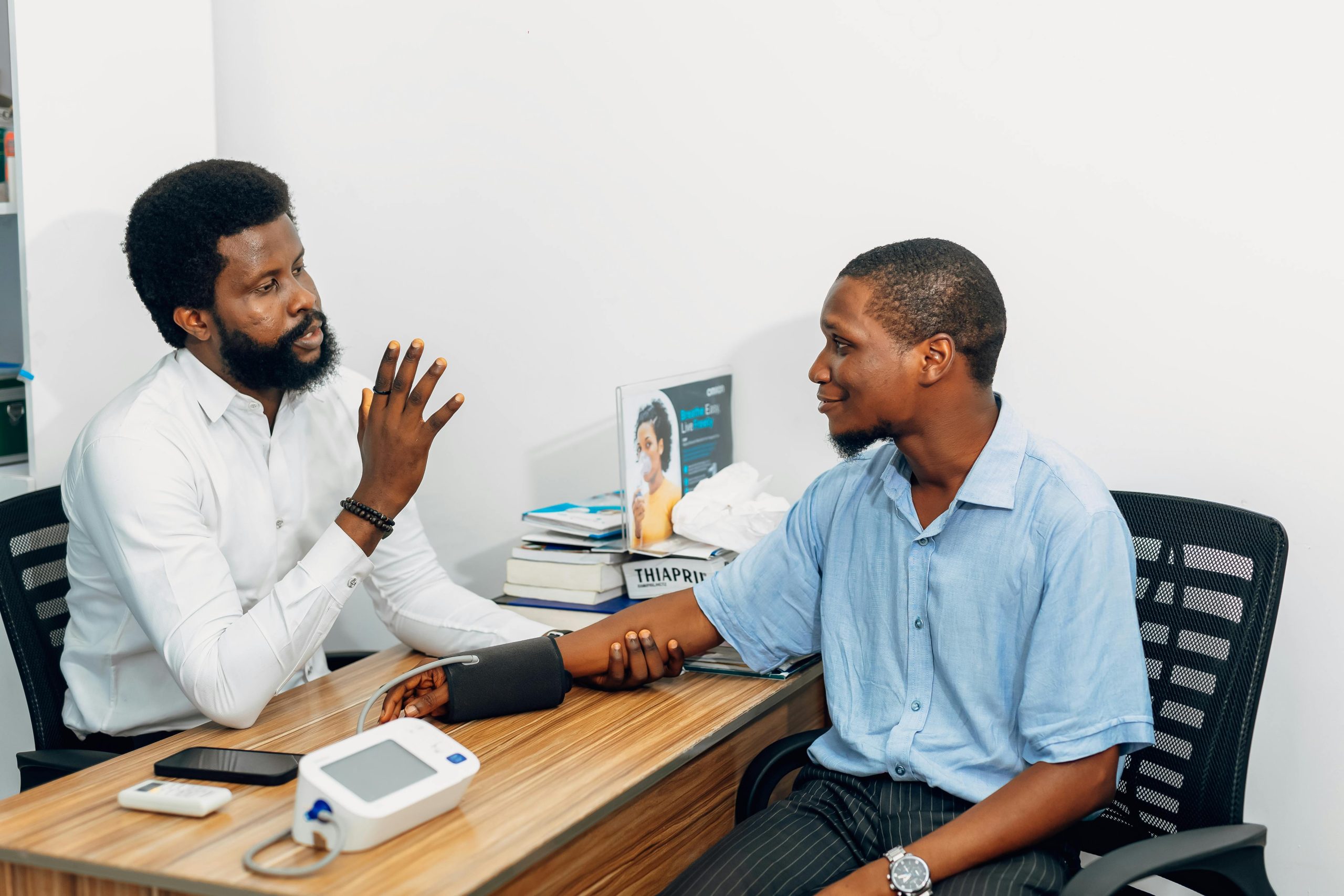A medical professional consults with a patient during a blood pressure checkup in Lagos, Nigeria.